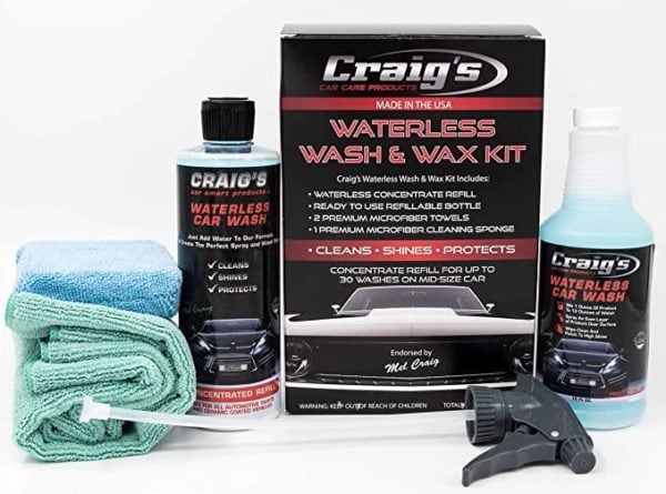 A complete car care kit, including a large black and red labeled box of Craig’s Waterless Wash & Wax Alternative for Drought, a blue microfiber towel, a green microfiber towel, a white spray nozzle, and a bottle of Craig's concentrated refill solution with a matching label—a perfect wax alternative ideal for drought conditions.