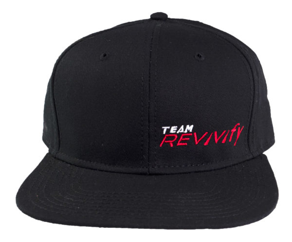 The Snap Back Cap is black with "TEAM REVIVIFY" embroidered on the front in red and white. It boasts a flat brim and a structured crown.