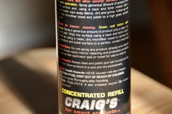 Close-up of a product label on a 16oz refill bottle of "Craig's Waterless Wash & Wax" from Craig's Car Smart Products. The text details application instructions, health hazards (H316), and contact information, with an emphasis on keeping it out of reach of children.