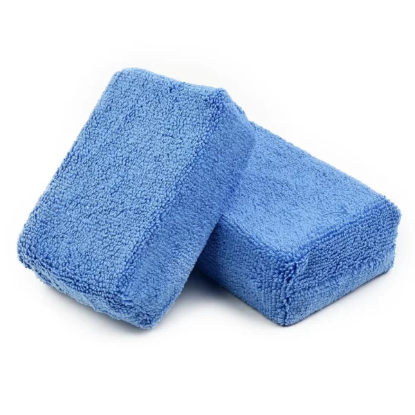 Two Microfiber Sponges in blue are arranged on a white background. The rectangular-shaped sponges feature a soft, textured surface.