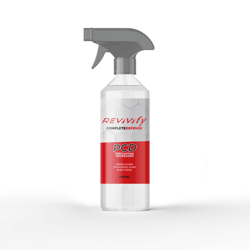 A translucent plastic spray bottle labeled "Revivify PCD" with a red and white design. The bottle appears to contain a cleaning or protective solution, holding 500 ml of liquid. The spray nozzle is gray.